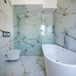 A large bathroom made of white marble