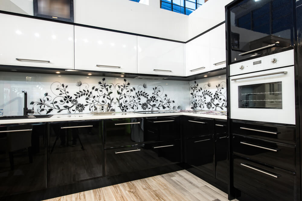 high contrast kitchen with white countertops & floral walls